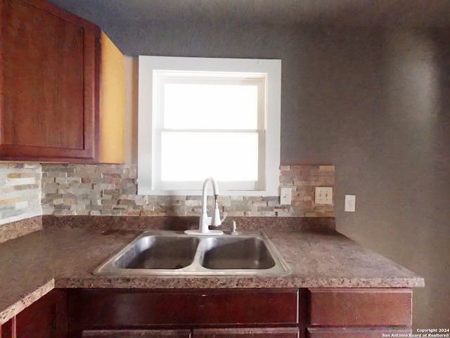 kitchen with tasteful backsplash and sink