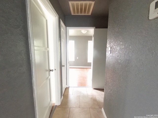 hallway featuring light tile patterned floors