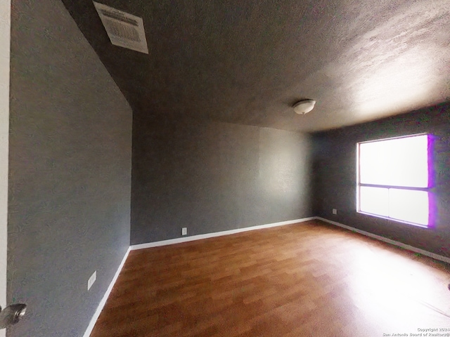 unfurnished room featuring hardwood / wood-style flooring