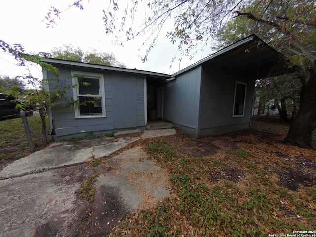 rear view of property with a carport