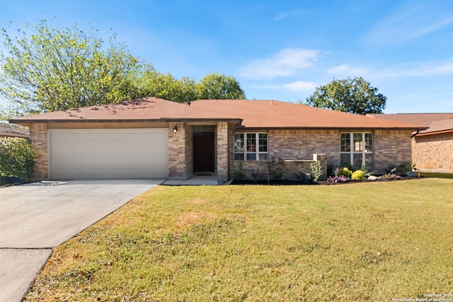 ranch-style house featuring a garage and a front yard