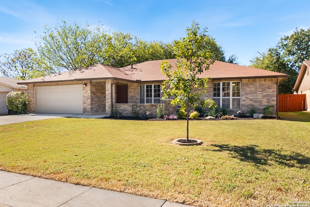 single story home featuring a front lawn and a garage