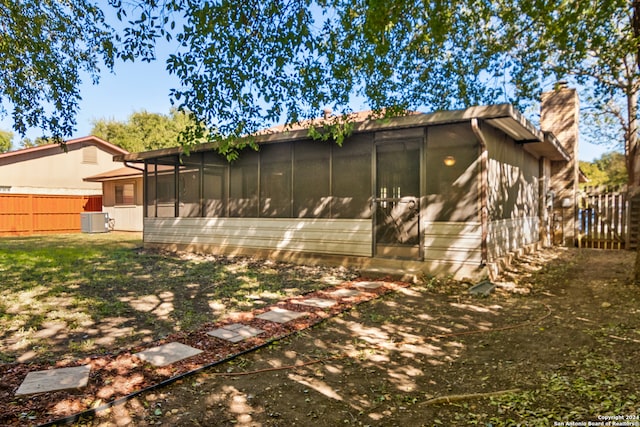 view of side of property featuring cooling unit and a sunroom