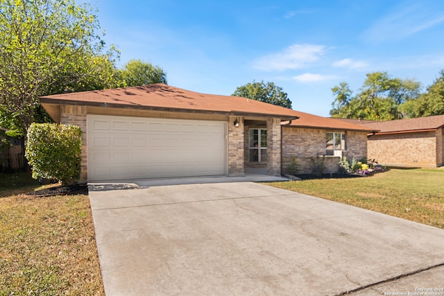 ranch-style home with a front yard and a garage