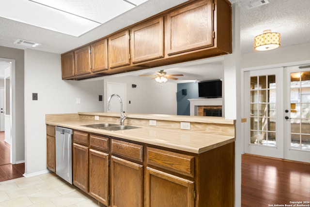 kitchen with french doors, ceiling fan, sink, light hardwood / wood-style flooring, and dishwasher