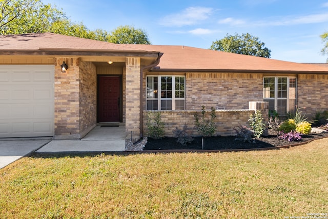 single story home featuring a garage and a front lawn