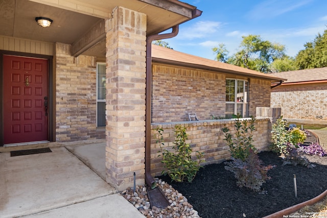 view of exterior entry with a porch