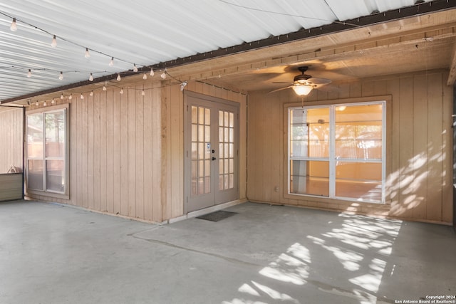 unfurnished sunroom with plenty of natural light, ceiling fan, and french doors