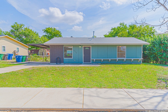 single story home with a front yard and a carport