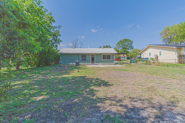 back of property with a patio area and a yard