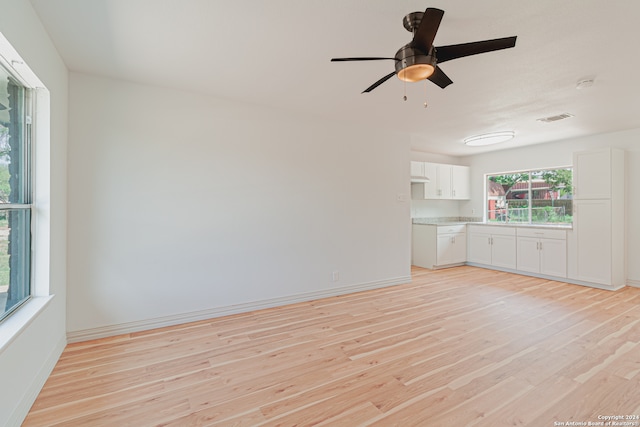 unfurnished living room with ceiling fan and light hardwood / wood-style flooring