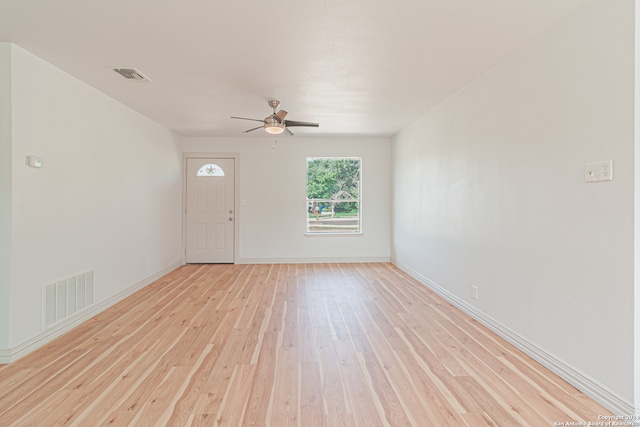 spare room with light hardwood / wood-style floors and ceiling fan