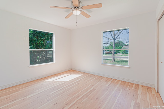 spare room featuring light hardwood / wood-style flooring and ceiling fan