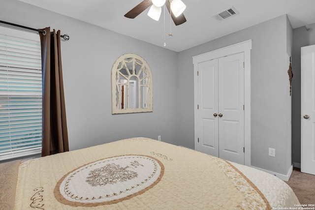 bedroom with carpet flooring, ceiling fan, and a closet