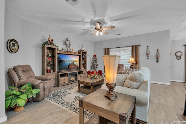 living room featuring ceiling fan and hardwood / wood-style floors