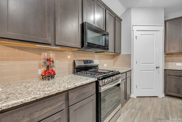 kitchen featuring backsplash, dark brown cabinetry, stainless steel range with gas cooktop, and light wood-type flooring