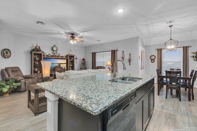 kitchen featuring sink, hanging light fixtures, light hardwood / wood-style flooring, stainless steel dishwasher, and an island with sink