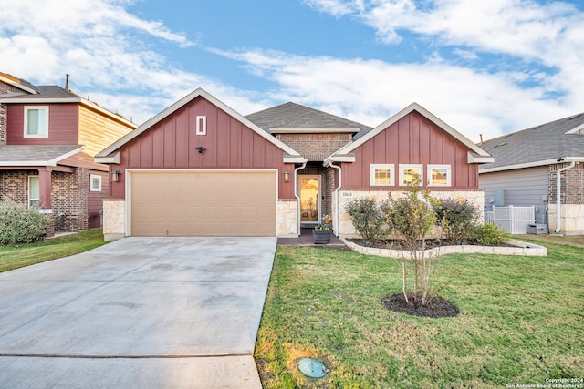 view of front of home with a garage and a front yard