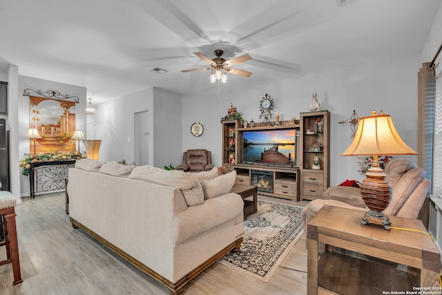 living room featuring light wood-type flooring and ceiling fan