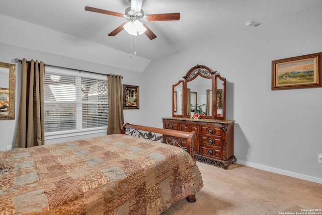 bedroom featuring light colored carpet, vaulted ceiling, and ceiling fan