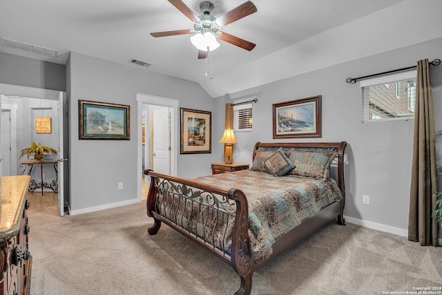 bedroom with ceiling fan, light colored carpet, and lofted ceiling