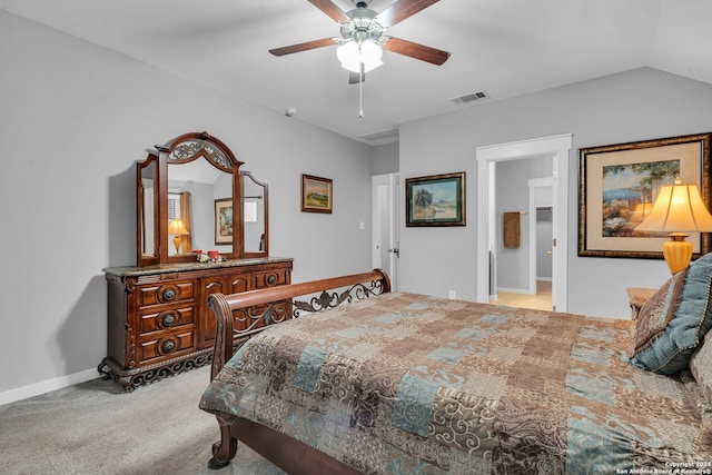 carpeted bedroom featuring ceiling fan, ensuite bathroom, and vaulted ceiling