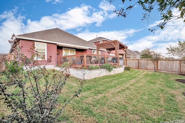 back of property with a lawn and a wooden deck