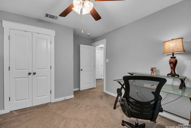 carpeted home office featuring ceiling fan