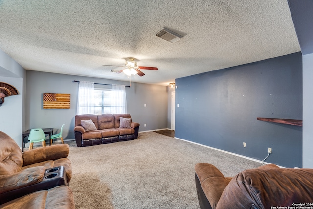 living room featuring carpet flooring, ceiling fan, and a textured ceiling