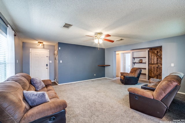 carpeted living room featuring a textured ceiling and ceiling fan