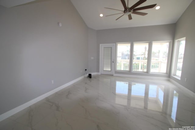 900 Padre Blvd Unit 307, South Padre Island, TX 78597 - empty room with baseboards, ceiling fan, high vaulted ceiling, light marble finish flooring, and recessed lighting