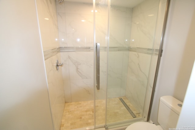 bathroom with toilet and walk in shower