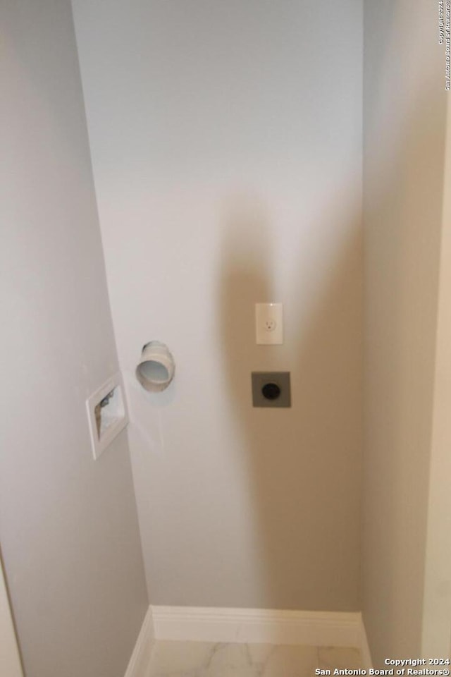 900 Padre Blvd Unit 307, South Padre Island, TX 78597 - laundry area featuring hookup for an electric dryer, marble finish flooring, baseboards, and washer hookup