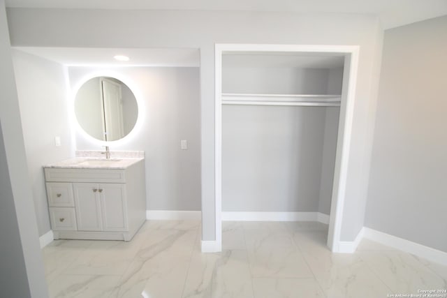 900 Padre Blvd Unit 307, South Padre Island, TX 78597 - bathroom featuring marble finish floors, vanity, and baseboards