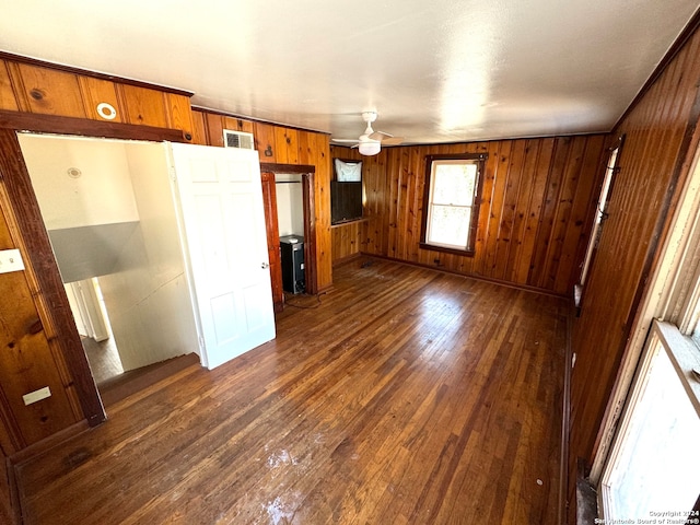 interior space featuring wooden walls and dark wood-type flooring