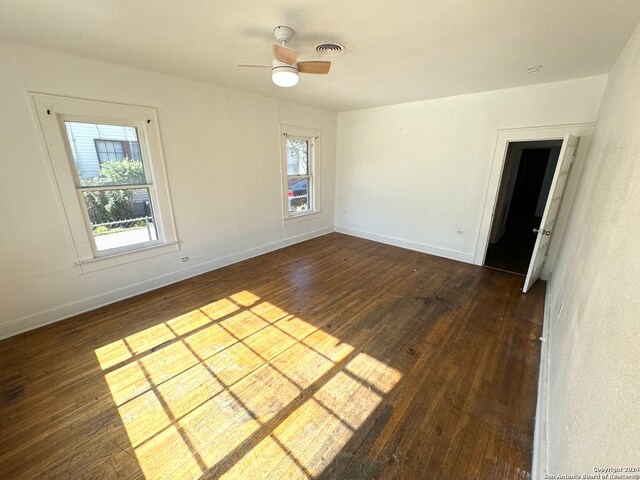 spare room featuring ceiling fan and dark hardwood / wood-style floors