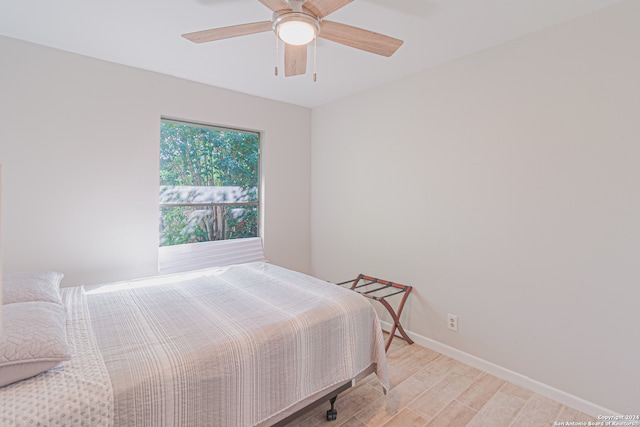 bedroom with ceiling fan and light hardwood / wood-style floors