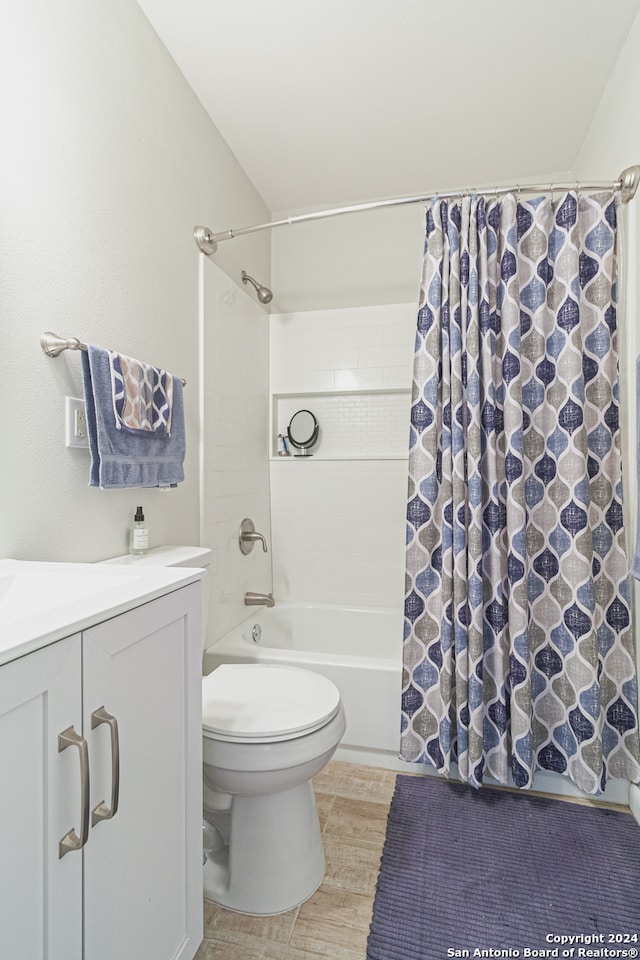 full bathroom featuring vanity, shower / bath combination with curtain, and toilet