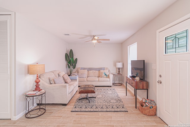 living room featuring light hardwood / wood-style floors and ceiling fan