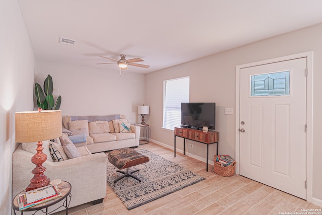 living room featuring ceiling fan and light hardwood / wood-style flooring