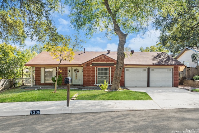 ranch-style home featuring a front lawn and a garage