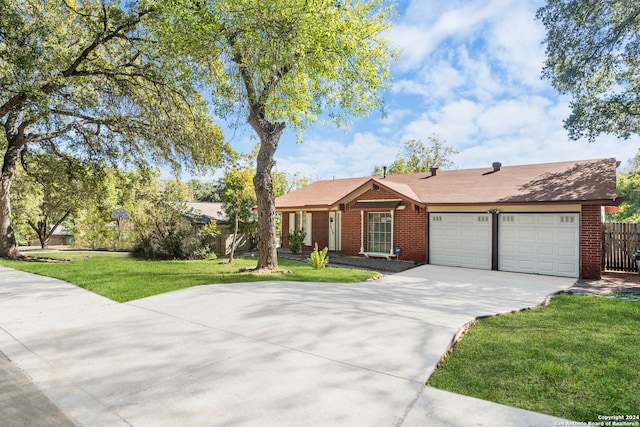 ranch-style home with a front lawn and a garage