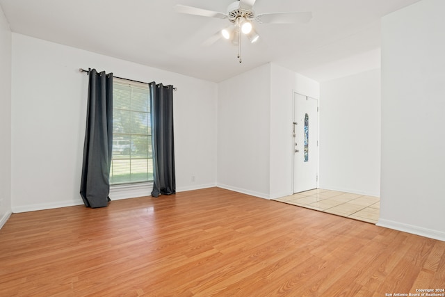 empty room with light hardwood / wood-style floors and ceiling fan