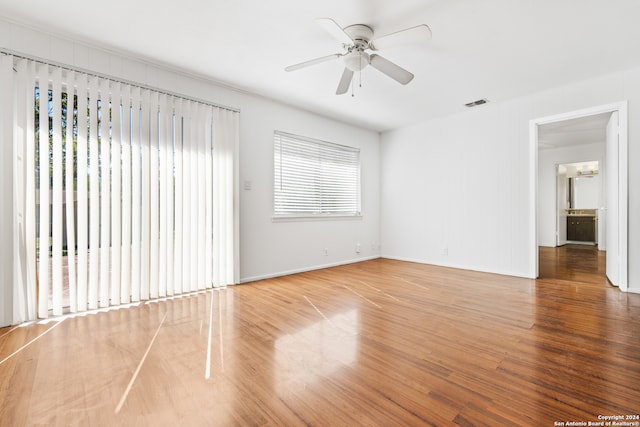 empty room featuring hardwood / wood-style floors and ceiling fan