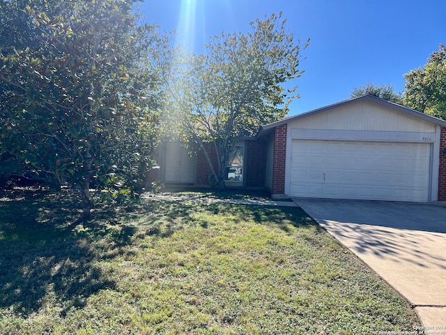 view of front of home with a garage and a front lawn