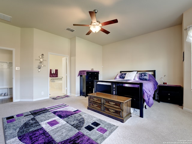 carpeted bedroom with ensuite bathroom and ceiling fan