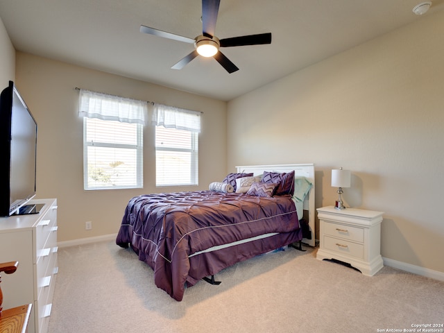 bedroom with light colored carpet and ceiling fan