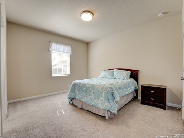 bedroom with light carpet