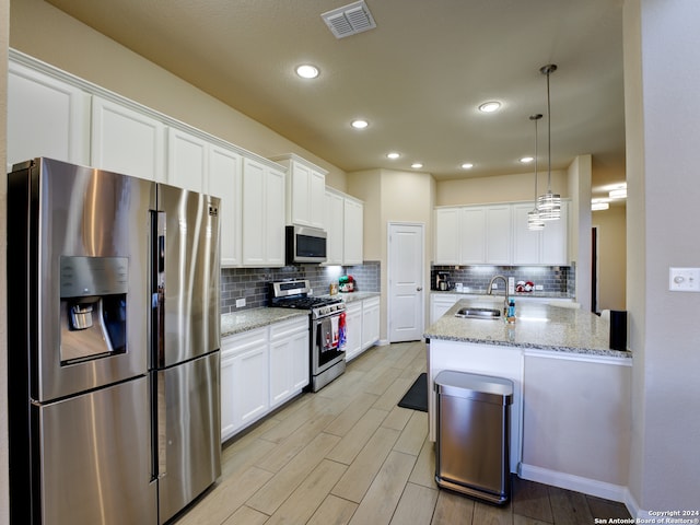 kitchen featuring white cabinets, stainless steel appliances, and sink