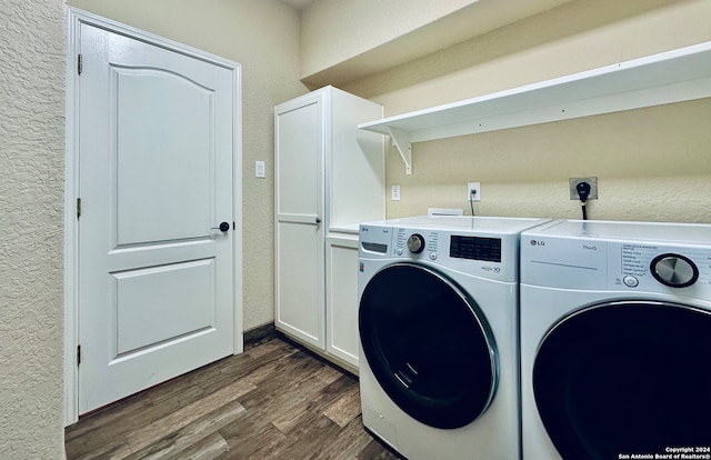 laundry area with dark hardwood / wood-style flooring, cabinets, and separate washer and dryer